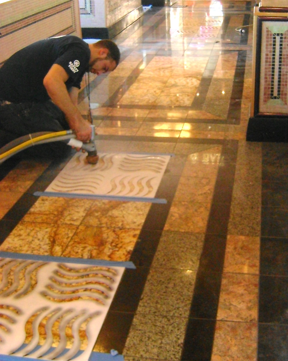 ROG3 surface specialist performing soft-blast corrective work on a commercial stone floor
