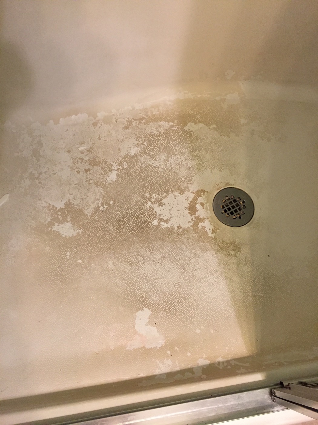 Commercial shower surface before corrective restoration